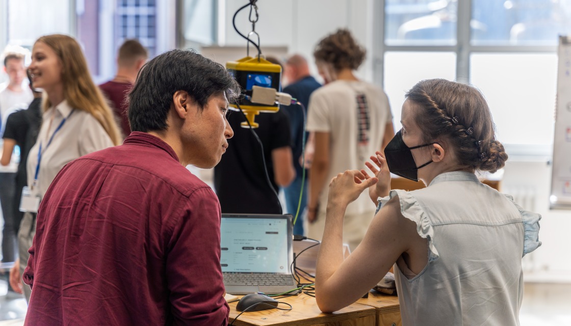 Student and scientist working together in prototype workshop.