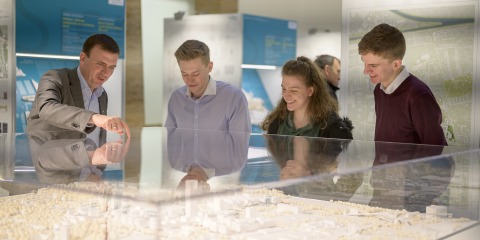 Visitors in front of the model Siemensstadt 2.0
